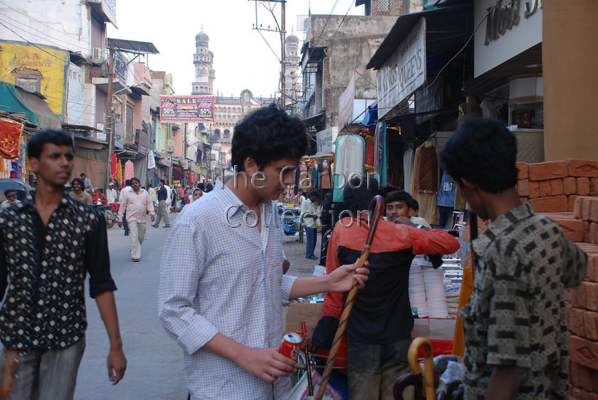 DSC 0170 
 Man shopping in Lad Bazar, Hyderabad, India. 
 Keywords: hyderabad india indian street market shopping